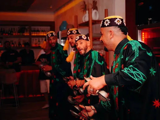 Gnawa musicians performing in traditional embroidered dress