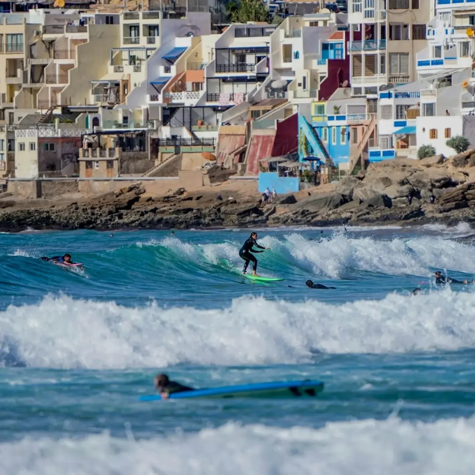 Surfing on a turquoise wave near Taghazout, Agadir